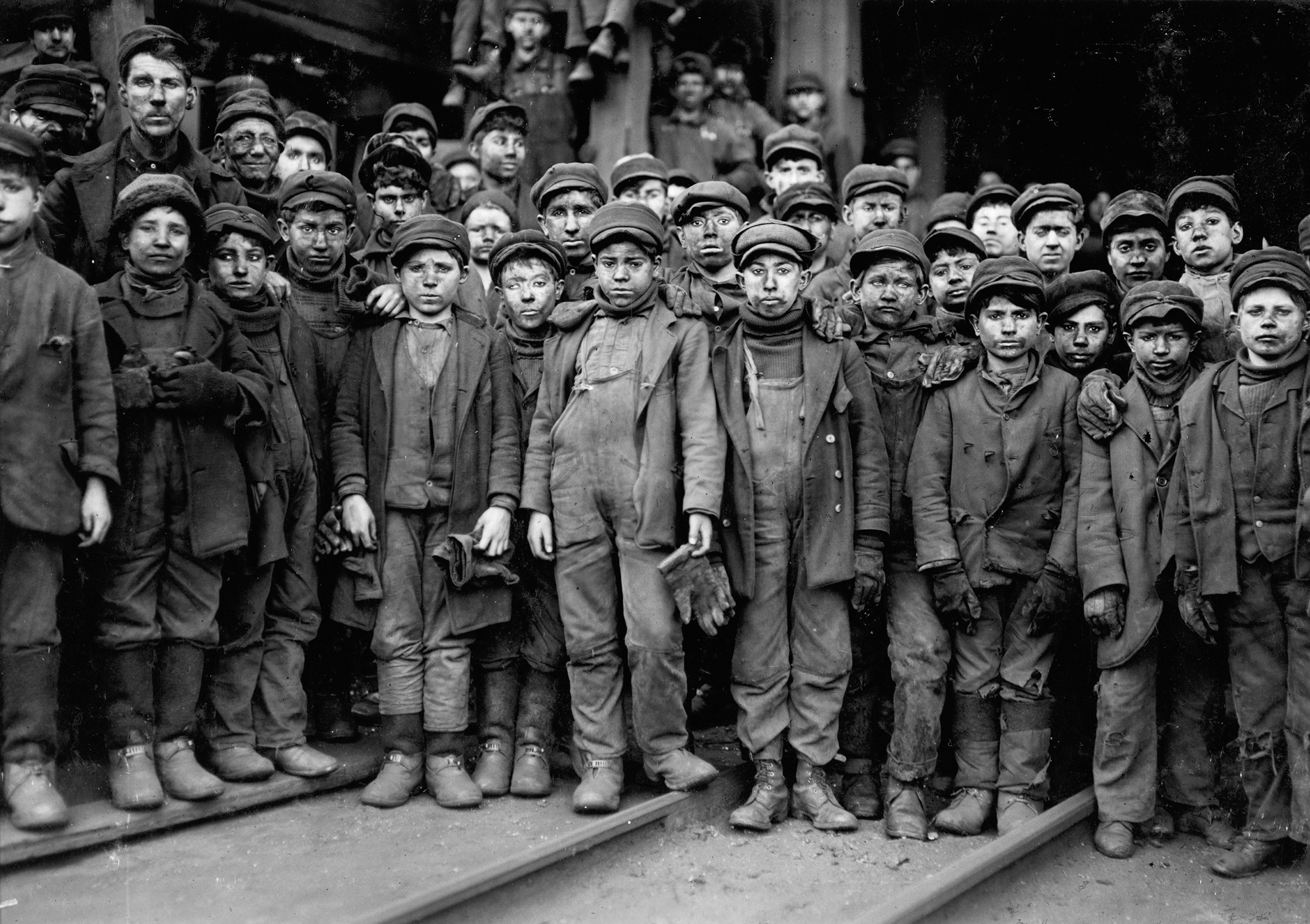 Black and white photograph of a group of children working in a factory.